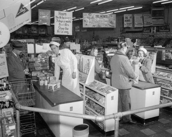 Two checkout counters at the Hi-Lo supermarket at 2038 Jenifer Street, with unidentified clerks and  customers.