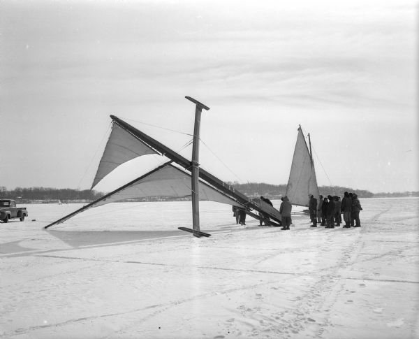 The "May-Bid" iceboat of Oshkosh is shown just after it capsized during the Hearst Trophy challenge series on Lake Monona. Boats from the Madison Four Lakes Ice Yacht club are the defending champions in the weekend competition.