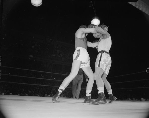 Dave Miyagawa, University of Wisconsin 132-pound boxer, and Art Nelson, University of Syracuse boxer in a match at the University of Wisconsin-Madison Field House.