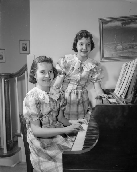 Portrait of Connie (seated) and Kathie Froker, twin daughters of Dean and Mrs. R.K. Froker of Shorewood Hills. He is the dean of the University of Wisconsin College of Agriculture.