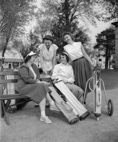 Four members of the Women's Municipal Golf Association wait to tee off at the Monona Golf Course.  Left to right: Louise Frye, Phyllis Overton, Irene Mueller, and Lorraine Schneider.