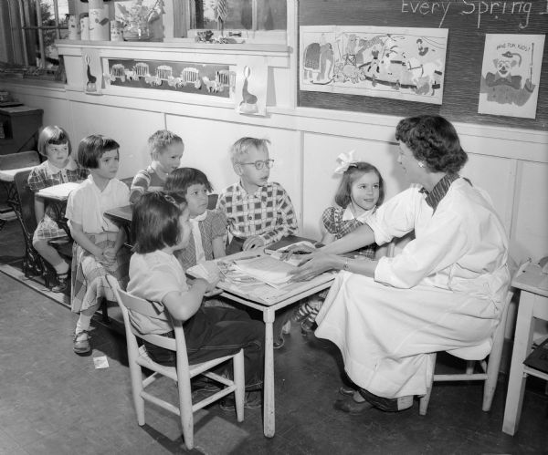 Teacher Mrs. Barbara Austin sitting with seven of her students in a classroom at Morningside Sanatorium at 300 Femrite Drive. The young patients averaged about a year's stay while they recovered from tuberculosis.
