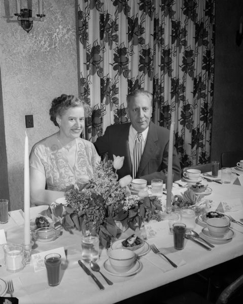 Frederic E. and Elizabeth W. Risser sit at the dinner table during the Cosmos Dance Club 30th Anniversary dinner dance.