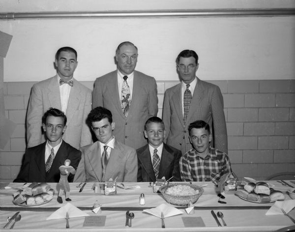 Sport captains for the four sports teams were honored at the annual Father and Son Banquet at the Frank Allis School. Seated, left to right, are: Don Wagner, Wayne Schmudlach, Phil Chase, and George Stratton. In back are, left to right: coach Joe Braun, Arthur (Dynie) Mansfield, University of Wisconsin baseball coach and main speaker, and principal Walter Barr.