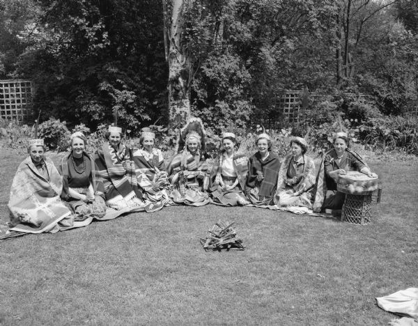 Tribe leaders and officers of the Nakoma Welfare League at the annual May breakfast. Left to right are: Mrs. John (Kathryn) Stauffer, Mrs. Virgil (Helen) Herrick, Mrs. John (Vera) Tramburg, Mrs. Robert (Ruth) Goetz, Mrs. Stewart (Lillian) Honeck - "Big Chief," Mrs. H.L. (Eleanor) Halvorsen, Mrs. Glen H. (Frances) Bell, Mrs. G.E. (Eva) Watson - "Big Wampun," and Mrs. Arnold G. (Jean) Gehner - "Big Scribe."