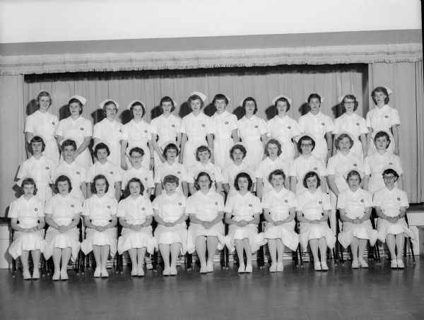 Group portrait of 34 student nurses who received their nursing caps, signifying the completion of their first year of nurse's training at Madison General Hospital.