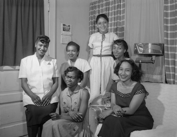 Six committee members of the Alpha Omega Phi women's organization dedicated to community social service plan an upcoming party. Seated in front, left to right: Ruby Davis and Dolores Simms Greene. Others, left to right: Rose Abernathy, Doris Barlow Kinney, Gwen Shellie Elvord, and Mary Elvord Smith.