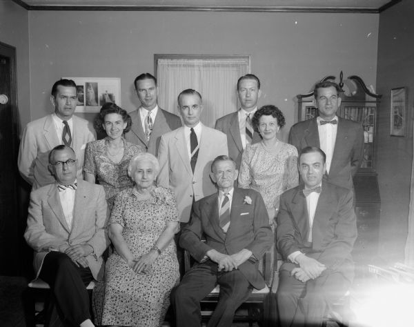 Group portrait of Herman and Anna Tilker and their nine children who are gathered for the Tilker's 50th wedding anniversary.
