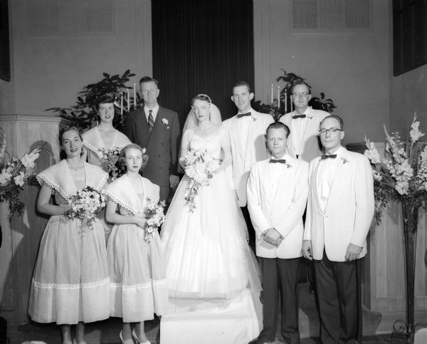 Group portrait of the Holm-Smith wedding party and minister at First Baptist Church. The bride is Joan Marie Holm and the groom is Peter Byrd Smith. The Rev. Charles Bell, Jr. officiated.