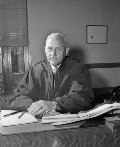 Portrait of Federal Judge Patrick T. Stone wearing his judicial robe and seated at a desk. He is the judge of the U.S. District Court in Madison.