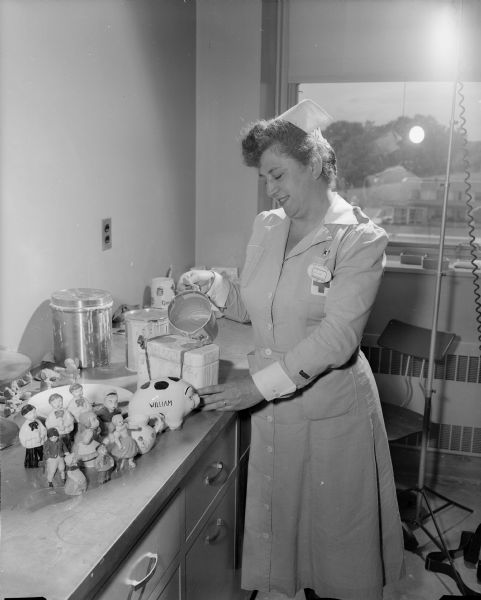 Mrs. Albert H. (Kath) Mayer works as one of the Gray Ladies (volunteers) of the Red Cross and pours a mold in the ceramics room in the occupational therapy section at the Veteran's Administration Hospital.