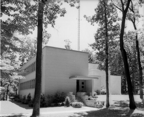 Exterior view of WIBA radio broadcasting studio at 3800 Regent Street near Hoyt Park in a wooded setting.