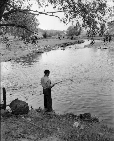 George Karls of Waunakee is shown fishing in Cross Plains creek.