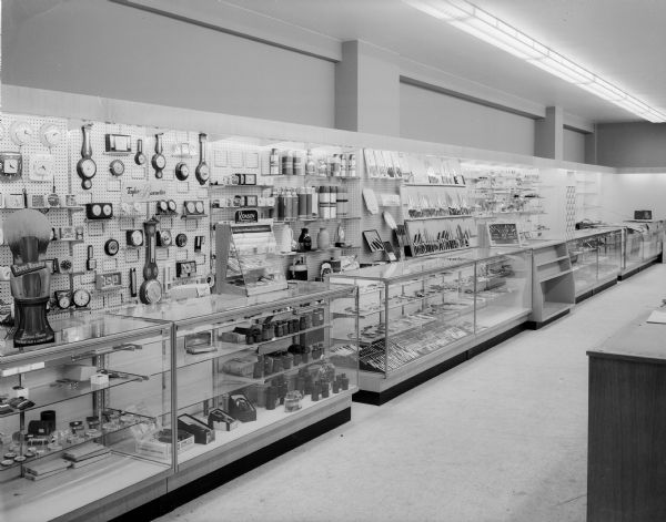Wolff, Kubly and Hirsig Company opens new store on Monday, June 29th. Pictured is the first floor which contains photography, luggage, cutlery, giftware, and the bath shop. Clocks and watches are featured in this photograph.