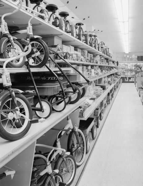 Wolff, Kubly and Hirsig Company opens new store on Monday, June 29th. Pictured is the second floor which is devoted to toys, sporting goods, trains, records, dolls and furniture. Featured in these photographs are bicycles, tricycles and model kits.