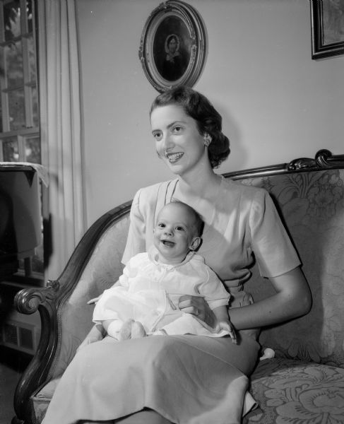 Portrait of Mrs. Joseph B. (Nancy) McNamara and her six-month-old daughter, Margaret Ann from Midland, Texas who are visiting at the home of Mrs. McNamara's parents, Mr. and Mrs. Richard H. (Lucy) Marshall, 175 Lakewood Boulevard.