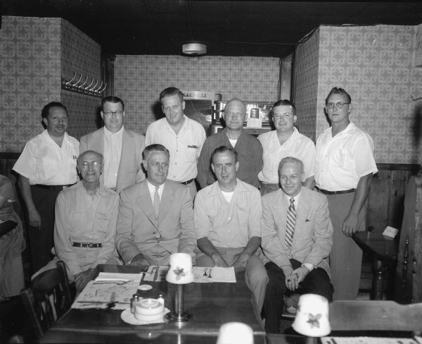 Officials of the Madison Bowling Association (men) who met to plan the 1953-54 season including the association's annual tournament and the 1954 state meet also to be held in Madison. Shown left to right in the front row are: Matt Zwank, Ray Sennett, Frank Gottsacker, and Eddie Toellner. Left to right in the back row are: Charles J. Allen, J.D. Wilson, Fritz Siewert, Les Ogilvie, Billy Dye, and Dwight Andreas. Bill Spraetz and Russ Albers were absent when the picture was taken.