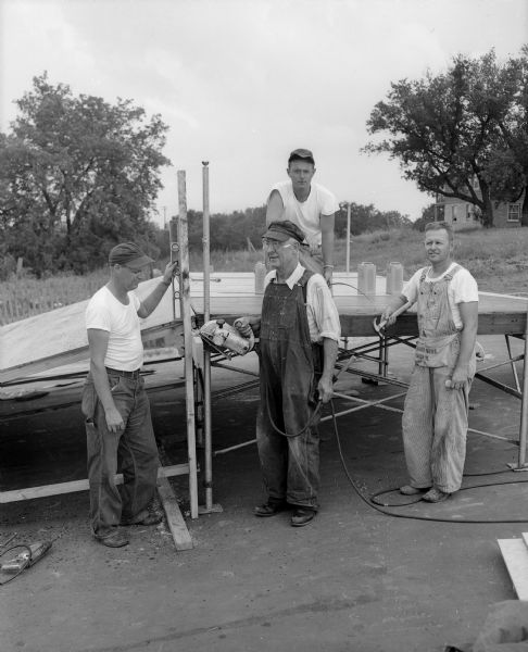 Four members of the Madison Parks Department building the ramp on Midvale Avenue for the upcoming Madison Soap Box derby. Left to right: Vie Cramer, Don Kelscher, Tom Short and Jerry Byrge.