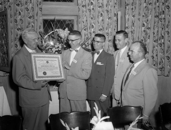 Charter for Madison's newest civic organization, the Madison Civitan Club was presented by Harvey Hartwig, past president of the Milwaukee Civitan Club, to ( left to right): Frank Schockmel, president, James M. Burgoyne, secretary, Robert E. McDermott, treasurer and Dr. Arno H. Fromm, vice president. The Board of directors includes Reg O. Smith, Dr. Clyde L. Rosen, Neil A. Woodington and M.J. Thomas.