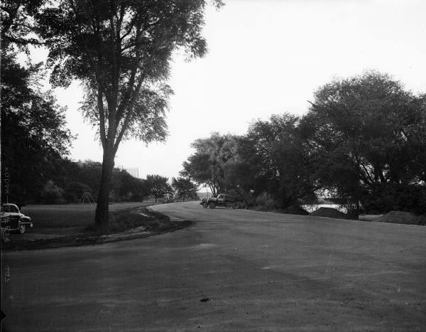 North Shore Drive (formerly Law Parkway) is open to traffic all the way from East Wilson Street to Proudfit Street, Brittingham Park Drive and West Washington Avenue. Paving of the last link between Broom and Bedford Streets was completed by Contractors Icke and Pankow, who repaired the base, and Payne and Dolan who did the asphalt surfacing. The photograph was taken looking east.