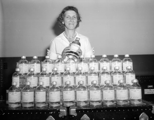 Angeline Stacey of Detroit, Michigan poses with 28 pint containers at the Badger Regional Blood Center. They represent a portion of blood she has donated since 1942. She plans to donate blood in every state.
