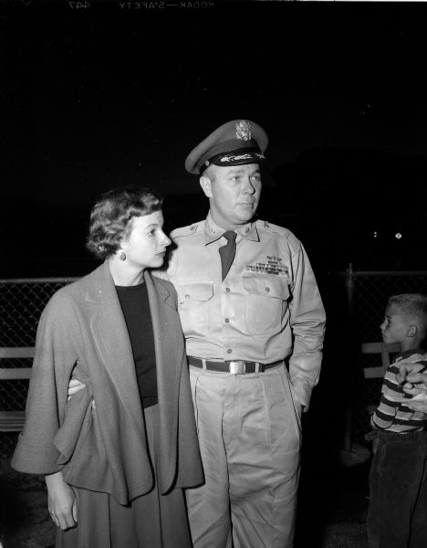 Colonel Collins H. Ferris stands beside his wife as he is greeted at the Madison airport upon returning from Japan. He was the commander at Truax Field from January to August, 1951 and acted as the deputy commander of the Tachikawa Japan Air Base.