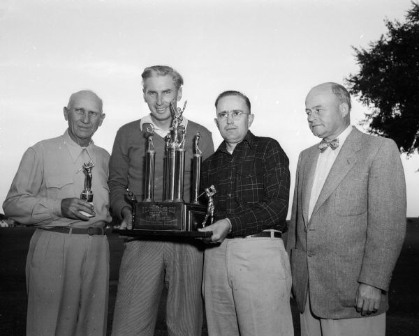 Group portrait of Wisconsin Public Links Tournament winners at the Monona municipal golf course. They are, from left: Al Pettigrew, Milwaukee; Erv Gargen, Milwaukee; Bob Van Etten, Madison; and Ed Hoffman, Oshkosh. 
