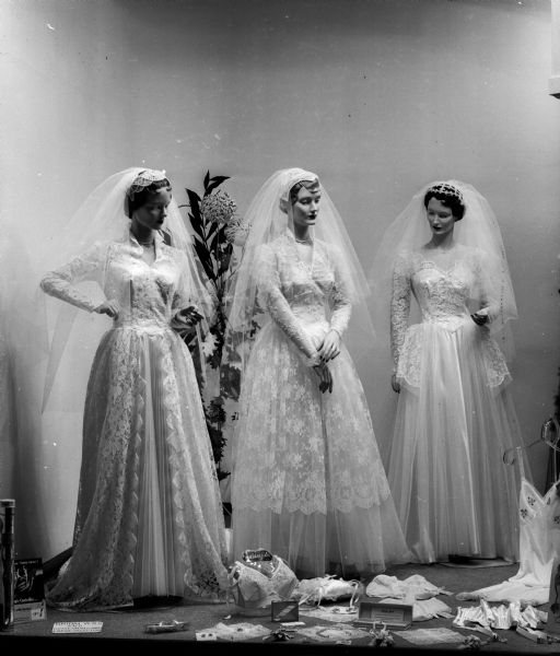 Mannequins in bridal dresses stand on display in the window of Cinderella Shop, located at 8 South Carroll Street.