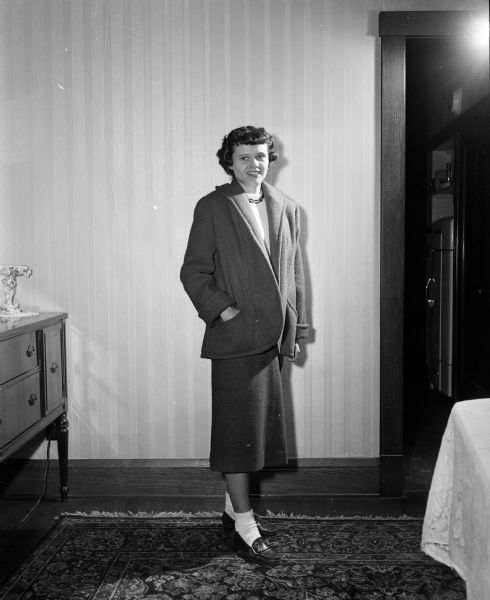 Sixteen-year old Ethel Miller models a coat her mother, Elizabeth (Mrs. Howard C.), made. The photograph was taken for an article about Elizabeth's seamstress work for herself and her daughter.