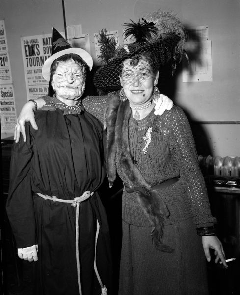 The Business Women's Bowling league staged its first annual dress up bowling session at the Plaza Alleys. Bowler Mae Schaefer dresses as a Halloween witch and Fran Younger is a Merry Widow.