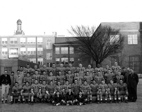 Outdoor group portrait of the West High Football Team, taken behind West High School.