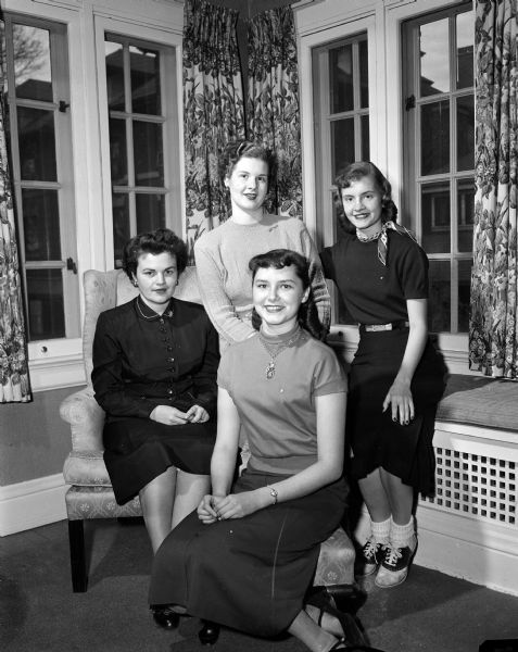 Group portrait of the women of Alpha Gamma Delta Sorority in charge of arrangements for the benefit bridge party at the chapter house for cerebral palsy. Left to right are: Lynne Ficken, Mrs. H.G. Roberts of Mt. Horeb, Mary Lou Trost of Milwaukee (foreground) and Barbara Elmore.