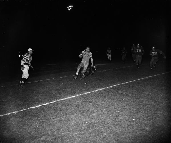 Action shot of the East High School vs. West High School football game as Mort Rabinowitz (West #49) scores a touchdown.