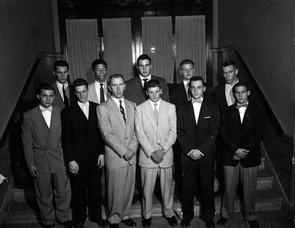 Group portrait of the Shrine All-City football squad. They are, from left to right, front row, Dick Hermanson, Central;Ted Williams, Central; main speaker Robert (Red) Wilson; Ron Skram, East; Dave Johnson, West; and Ron Schmelzer. Shown in the back row are Jim Schneiders, Wisconsin High; Bill Gothard, Central; Jim Holmes, Edgewood; Tom Weidholz, Edgewood; and Gordy Corcoran, West.