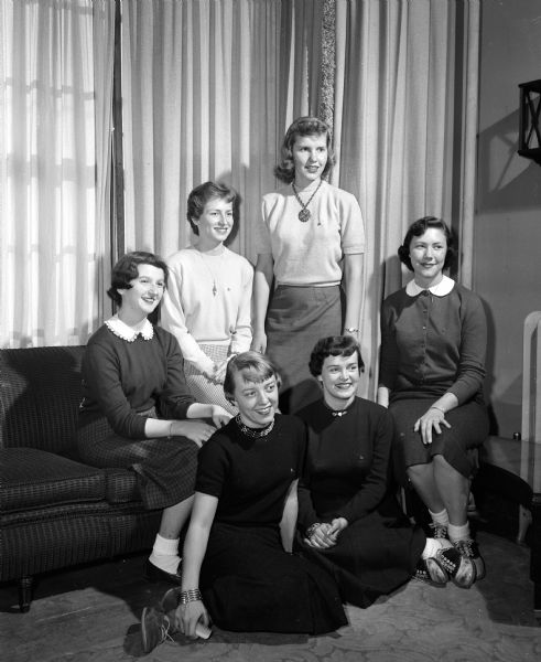 Six University of Wisconsin co-eds recently pledged to Delta Delta Delta sorority at 120 Langdon Street. Seated in front are: Nancy Dohr, left, and Mary Ellen Adler, right. In the background, left to right: Mary Durfee, Nancy Jueds, Barbara Boesel, and Jackie Julseth.