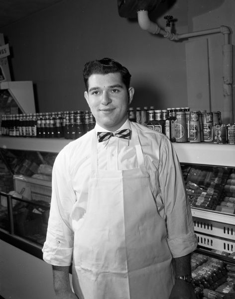 Portrait of John Troia, with bowtie, the manager of Millins Supermarket. The market was located at 553 West Main Street and formerly known as Vincent Troia Supermarket.