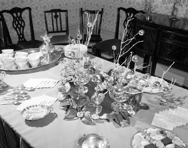 Decorative holiday tea table center piece created by Mrs. C.A. Sakrison of Middleton. The displays were sponsored by the West Side Garden Club and shown at the home of Genevieve (Mrs. Walter) Dakin of 4110 Mandan Crescent.