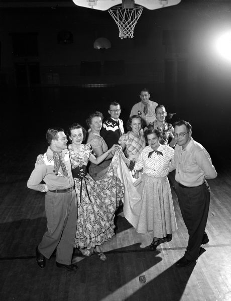 Group portrait of the Allis Promenaders who will sponsor their annual Empty Stocking Club dance at the Frank Allis School. Pictured are Rita and Bob Beckman, Irma Erb, Paul Payne, Hazel and Harry Woods, and Marie and Jack Jaeger. Caller Fritz Erb is behind the dancers.