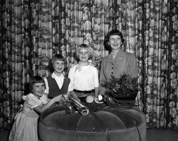 Geraldine Fitzpatrick, of 1504 Sumac Drive in Shorewood Hills, decorates her home for Christmas with children Cecelia (age 4), Gerry (age 6), and Lynn (age 10).