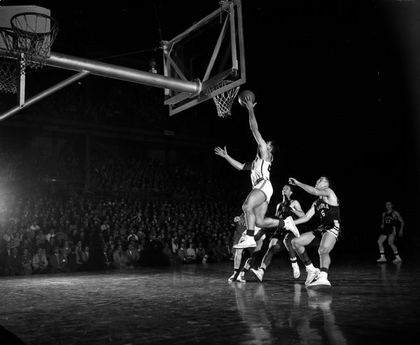 Wisconsin guard Ron Weisner making a lay-up in the basketball game between Wisconsin and Oklahoma at the University of Wisconsin fieldhouse.