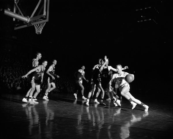 Wisconsin forward Mike Daly dribbles toward the basket during the basketball game between Wisconsin and Oklahoma at the University of Wisconsin fieldhouse.