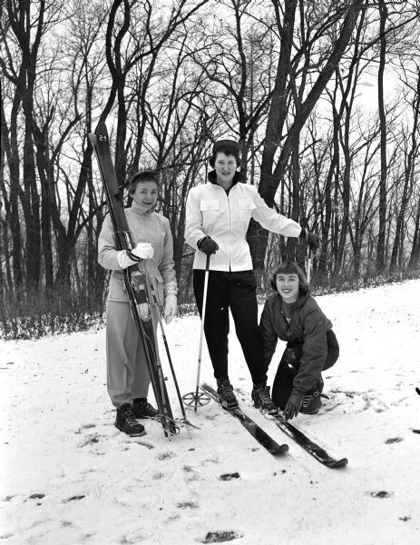 Participants in a YWCA ski class posing on a ski hill. They are, from left: Shirley Dickson, Gerry Birchard, and YWCA instructor Sylvia Tippet.