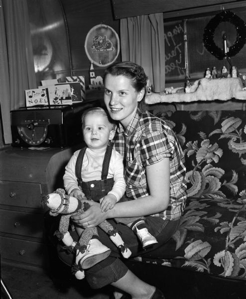 Portrait of Martha Verriden with her 14 month old son, Stevie. They lost their home and possessions in a fire at their trailer home at Oak Park Trailer Court, 3901 Packers Avenue. Soon after the fire they were assisted by The Empty Stocking Club, the Red Cross, and other organizations and indivuals.