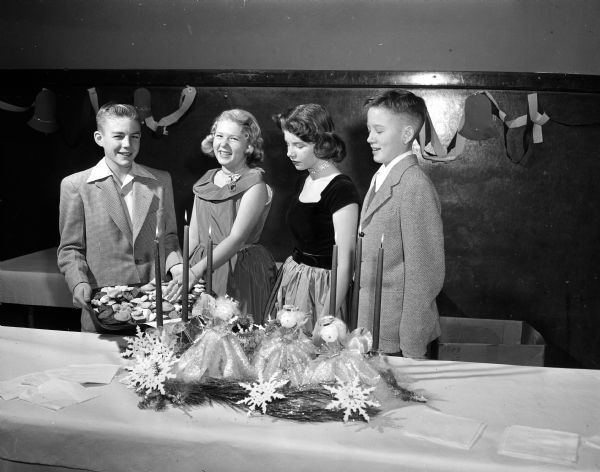 John Wilber, Patti Poehling, Suzanne Holly and Eric Peterson attend a dance in the Nakoma school gymnasium.