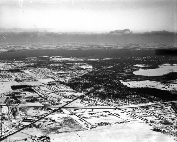 Aerial view of Crawford Heights looking northeast along Nakoma Road, across the West Beltline. The photograph shows Midvale Boulevard and Lake Mendota appears at the top, with Lake Wingra at right.