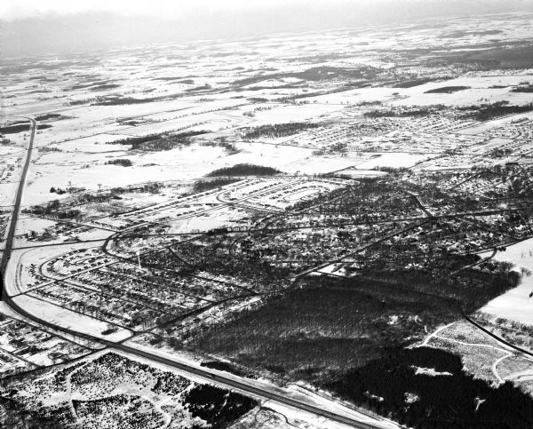 Aerial photograph of Crawford Heights looking west along the West Beltline. The photograph shows Nakoma Road, Midvale Boulevard, Cherokee School, and the Arboretum.