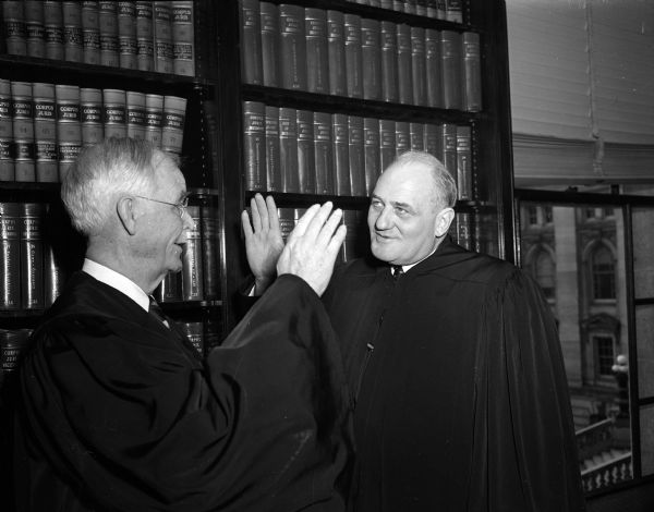 Justice Roland Steinle, recently elected to the Wisconsin Supreme Court, takes the oath of office from chief Justice Edward T. Fairchild. The photo was taken in the court's conference room.
