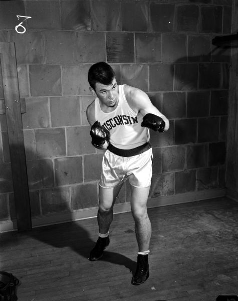 Portrait of Truman Sturdevant, a 178-pound boxer from Libertyville Illinois, in a boxing pose. He was named "Best Contender" in the 20th annual University of Wisconsin Tournament of Contenders.