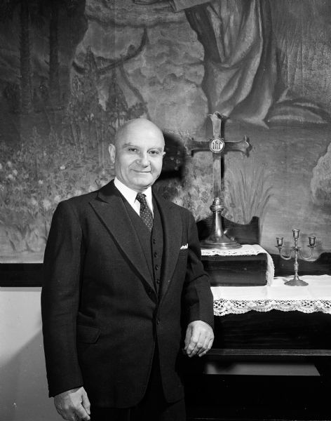 Portrait of Reverend Antonio Parroni standing at the altar of the Chiesa Italiana Methodist Church at 103 South Lake Street where he was minister from 1929 to 1954 and beyond.