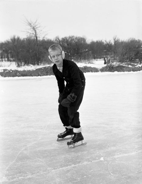 Portrait of Roger Steeper in speed skating stance. Roger was a double winner in the 3rd & 4th grade class at the City Speed Skating Races at Vilas Park. He broke the 50-yard race record with an 8.3 second effort, and also won the 100-yard race in 15.5 seconds.